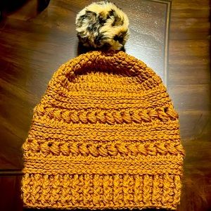 Hand crocheted hat with animal print Pom Pom.